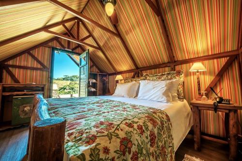 a bedroom with a bed in a room with wooden ceilings at Parador Cambará do Sul in Cambara do Sul
