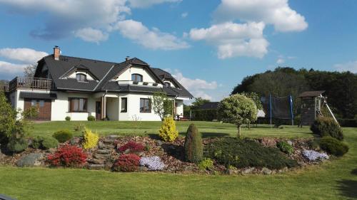 a large white house with a garden in the yard at Apartment Sendraž in Sendraž