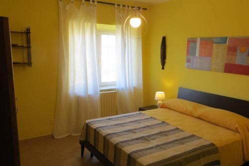 1 dormitorio con cama y ventana en Casa Martina, en Terracina