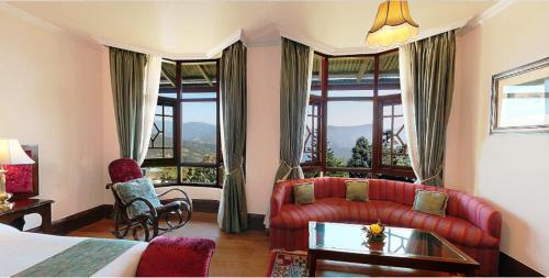 a hotel room with a bed and a couch at The Elgin Silver Oaks - Heritage Resort & Spa in Kalimpong