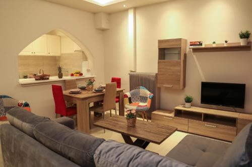 a living room with a couch and a table at Chrissomallis Apartments in Skiathos Town