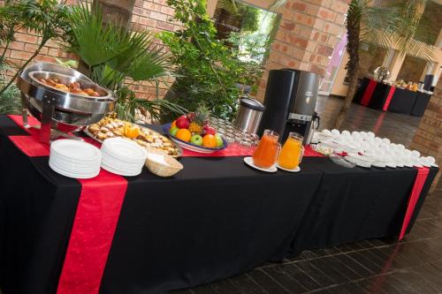 a black table with a buffet of food on it at CedarWoods of Sandton in Sandton