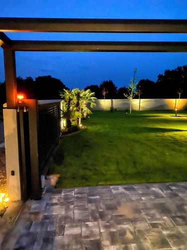 a view of a backyard at night at Villa Eni Medulin Sisan heated pool in Šišan