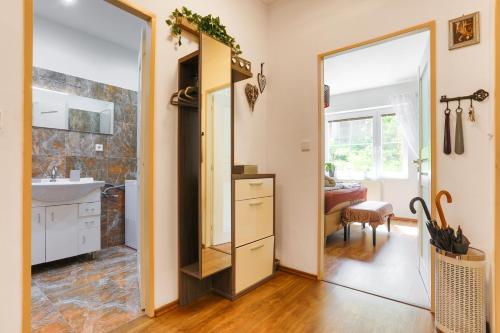 a bathroom with a sink and a mirror at Apartment Carla in Karlovy Vary