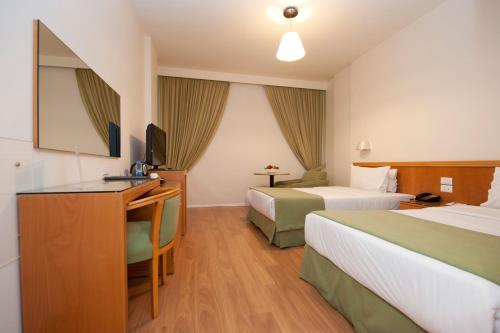 Postel nebo postele na pokoji v ubytování Hotel Cavalier