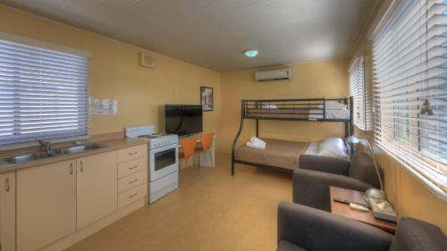 a small kitchen and living room with a bunk bed at Glenwood Tourist Park & Motel in Grafton