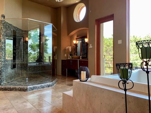 a large bathroom with a shower and a tub at Scenic Hill Country Retreat - Rhino Ranch in New Braunfels