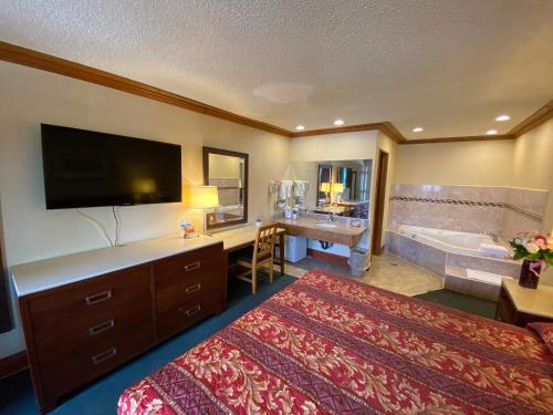 A bed or beds in a room at New Century Inn