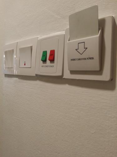 an electrical outlet with three switches on a wall at Seremban Inn in Seremban