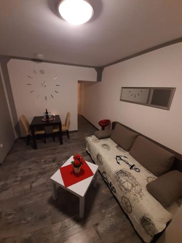 a living room with a couch and a table at Bed and Breakfast BLUE in BLUE in Komiža