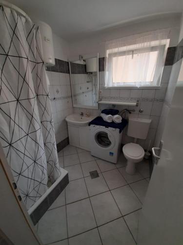 a small bathroom with a toilet and a sink at Bed and Breakfast BLUE in BLUE in Komiža