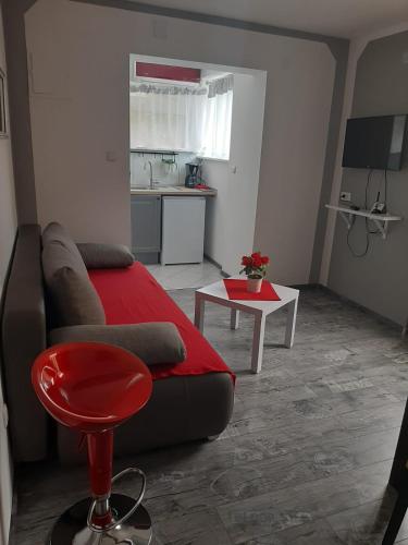 a living room with a couch and a table at Bed and Breakfast BLUE in BLUE in Komiža