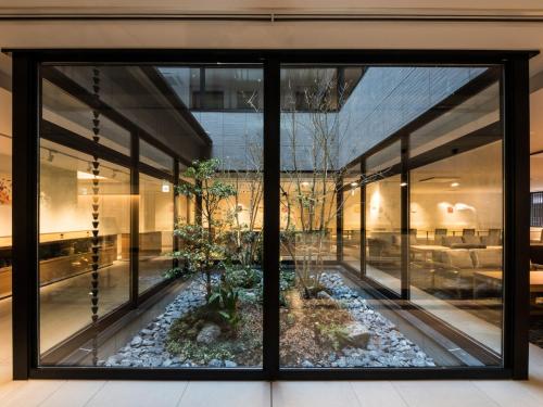 a window view of a building with a garden outside at Hotel Intergate Kyoto Shijo Shinmachi in Kyoto