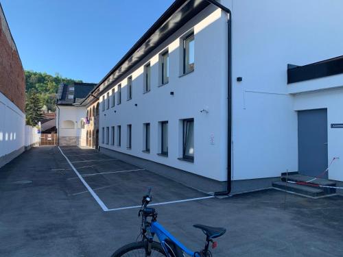 a bike parked in a parking lot next to a building at M70 Apartmanház in Miskolc