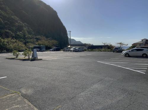 an empty parking lot with cars parked in it at Nishiizu Crystal View Hotel in Nishiizu