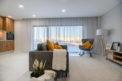 a living room with a couch and a chair at RM The Loft Experience in Setúbal
