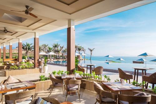 a restaurant with a view of the ocean at Fusion Resort Cam Ranh - All Spa Inclusive in Cam Ranh