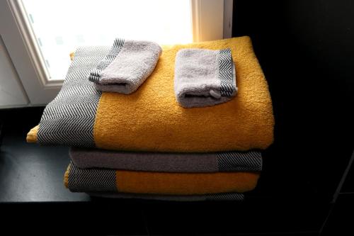 a pile of towels sitting on top of a table at Ilot Désille in Boulogne-sur-Mer