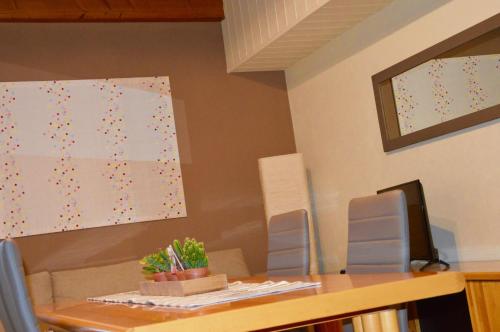 a table with two chairs and a painting on the wall at Poncinvs Residence in Bergamo