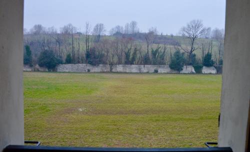 a view of a large field from a window at Poncinvs Residence in Bergamo