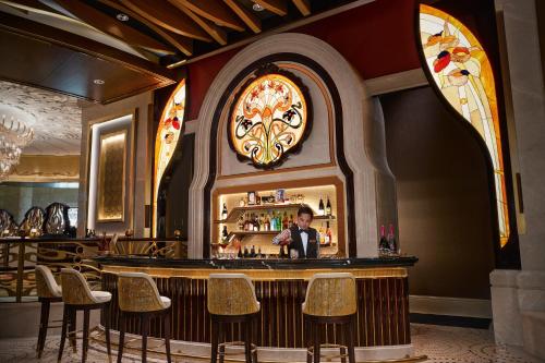 a bar in a restaurant with a man standing behind it at Galaxy Macau in Macau