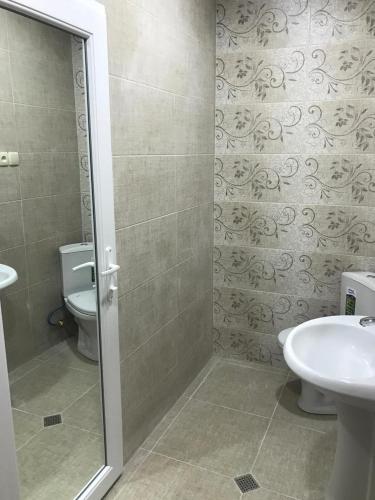 a bathroom with a toilet and a sink at Hotel Vardzia Terrace in Vardzia