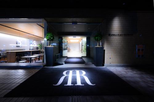an entrance to a restaurant with a lit up logo at RIHGA PLACE HIGOBASHI in Osaka