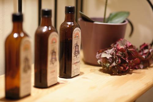 three bottles of wine sitting on a wooden table at Appartementhaus Absmeier in Bad Füssing