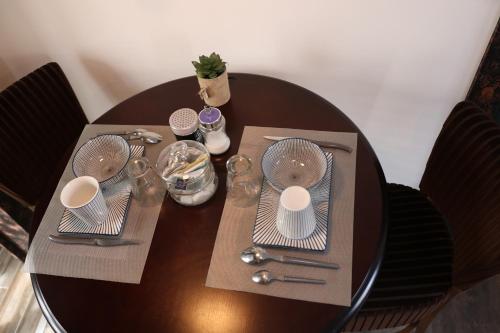 a table with plates and utensils on top of it at Ilot Désille in Boulogne-sur-Mer
