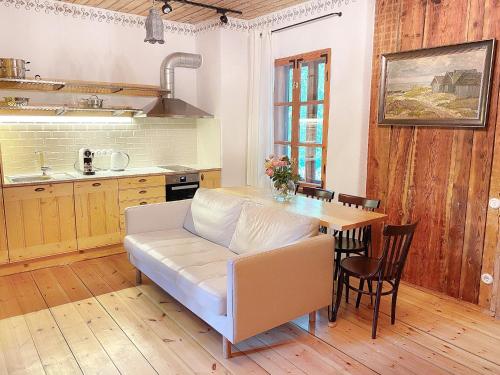 a living room with a couch and a table at Villa Gaida in Saulkrasti