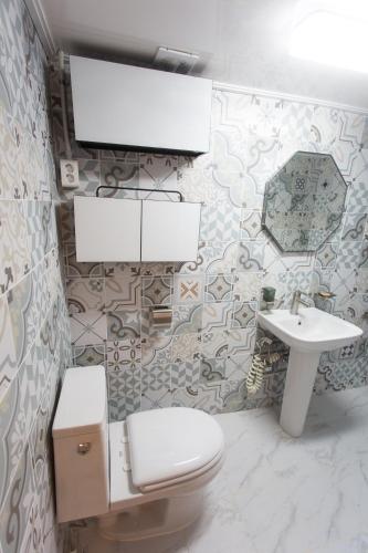 a bathroom with a toilet and a sink at Hanok1957 in Daegu