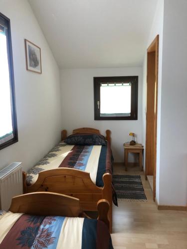 a bedroom with two beds and a window at Vila Noblesa Apartmaji in Most na Soči