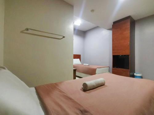 a bedroom with a bed with a pillow on it at Tropicana Hotel in Gemas