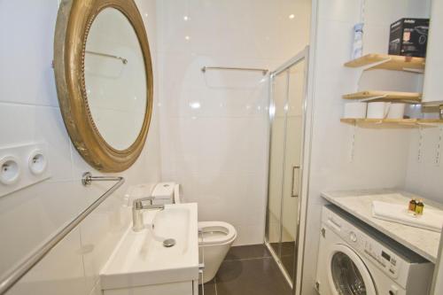 a bathroom with a toilet and a mirror at BEACHSIDE SUITE PANORAMIC - PROMENADE HOLIDAY in Nice