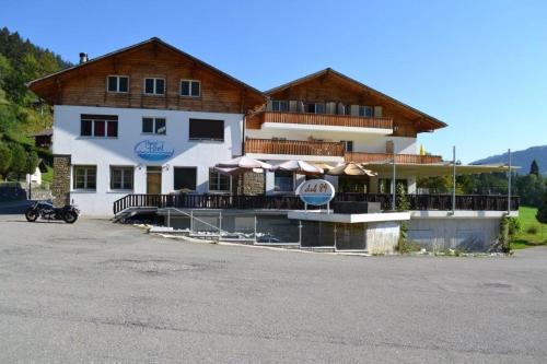 a large building with umbrellas in front of it at Hotel Bad Schwarzsee in Bad-Schwarzsee