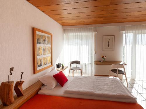 a bedroom with a bed and a table and chairs at Hotel Eikamper Höhe in Odenthal