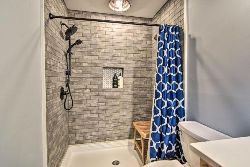 a bathroom with a shower with a blue shower curtain at Rustic Sunset Escape on 67 Acres Outdoor Kitchen in Sunset
