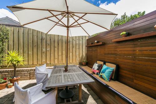 a table with an umbrella on a patio at Pride Street unit 1 13 in Torquay