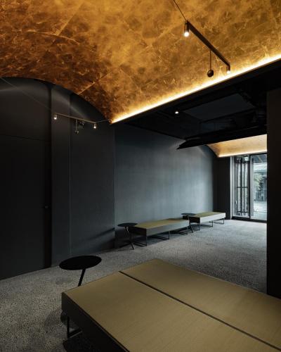 a room with two tables and a gold ceiling at FUGASTAY Shijo Omiya in Kyoto