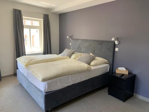 a large bed in a bedroom with a window at Hôtel - Restaurant " Victor Hugo" in Vianden