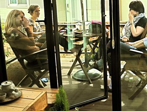 a group of people sitting at a table looking in a window at Guesthouse in Picture in Jeonju