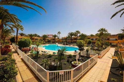 een uitzicht op een resort met een zwembad en palmbomen bij Luxury Cayetana, by Comfortable Luxury in Corralejo