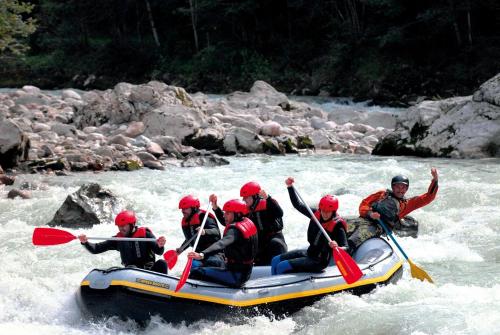 a group of people in a raft on a river at Pension Almhof Baumgarten in Bad Reichenhall