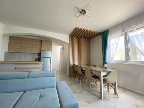 a living room with a blue couch and a table at B&T Apartments in Budva