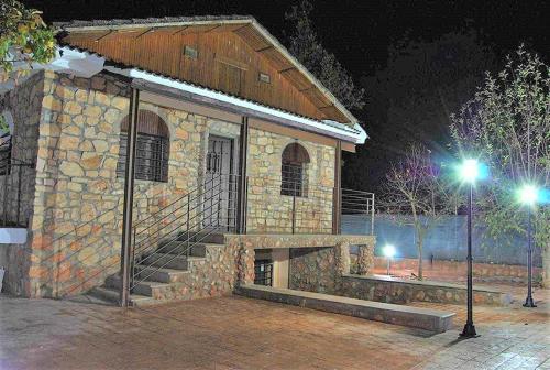 a stone building with a staircase in front at night at Casa Rural Villa Sem Sem in Ossa de Montiel