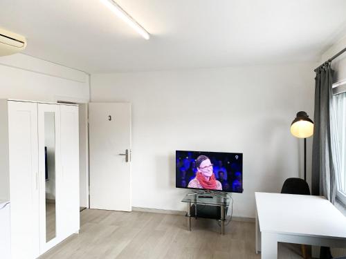 a living room with a flat screen tv on a wall at My-Skypalace Bad-Friedrichshall in Bad Friedrichshall
