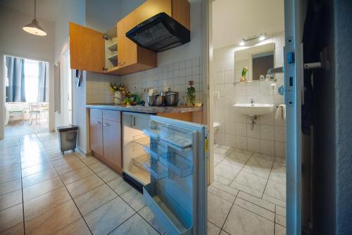 a kitchen with a sink and a counter top at Apartmenthaus Kaiser Friedrich in Potsdam