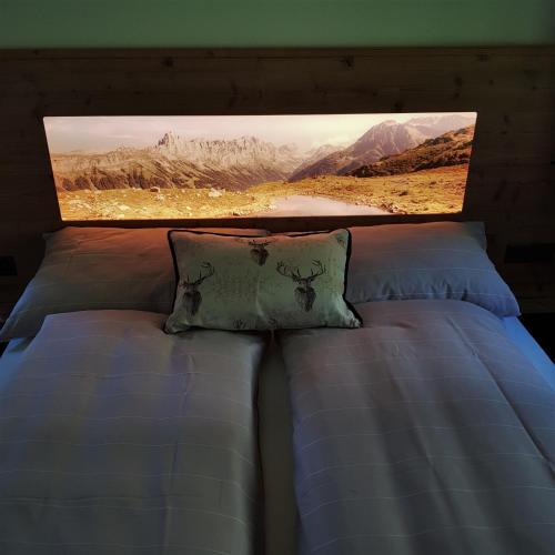 a bed with a picture on the top of it at Triftblick in Gadmen