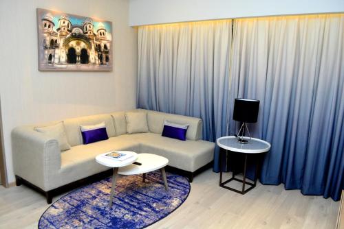 a living room with a couch and a table at Vivanta Vadodara in Vadodara