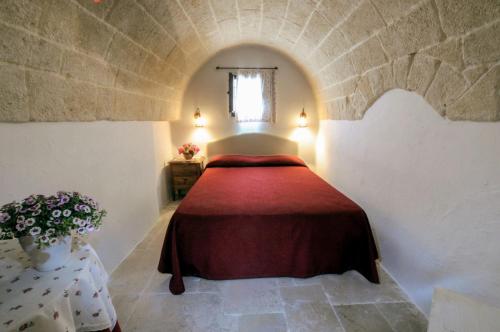 Ένα ή περισσότερα κρεβάτια σε δωμάτιο στο Masseria La Brunetta